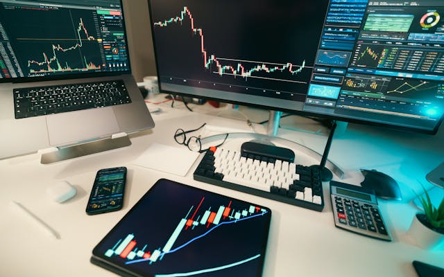 Trading desk with financial charts and technology displays